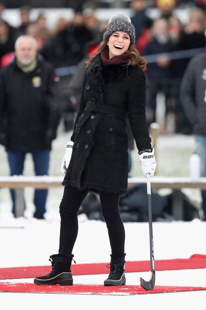 Kate laughes as she takes a shot at a Bandy hockey match in Sweden.
Photo: Getty