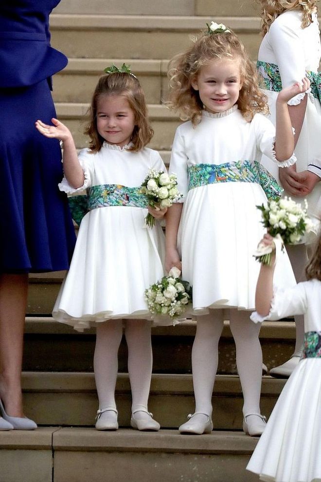 Bridesmaid Princess Charlotte (left,) waves to the crowds outside of St. George's Chapel.