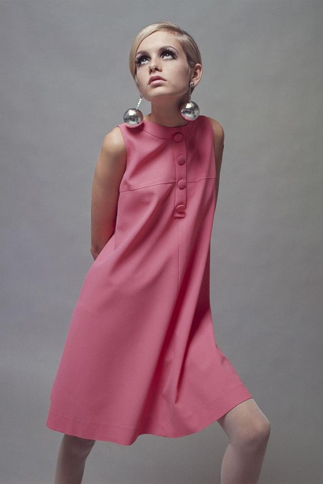 Twiggy poses in a bright pink and silver bauble earrings. Photo: Getty 
