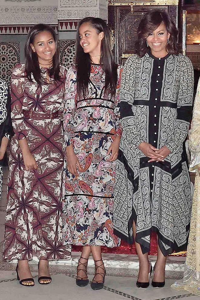 Taking a note from mom, Sasha and Malia Obama dress in long printed and paisley dresses for a dinner with Princess Lalla Salma in Marrakech. Photo: AP