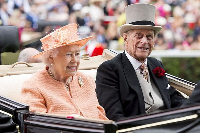 Queen Elizabeth II and Prince Philip riding in a carriage in Ascot, England.
