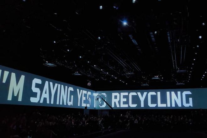Emporio Armani's running messages on sustainability across show space's four walls.