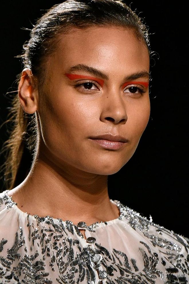 Prabal Gurung's fall collection centered about female empowerment had the models wearing equally strong, graphic looks. The skin is kept luminous and glossy and becomes a canvas for the the floating graphic eyeliner, in different colours. From green, blue to yellow, the structured shape is paired with a slick ponytail. Photo: Getty