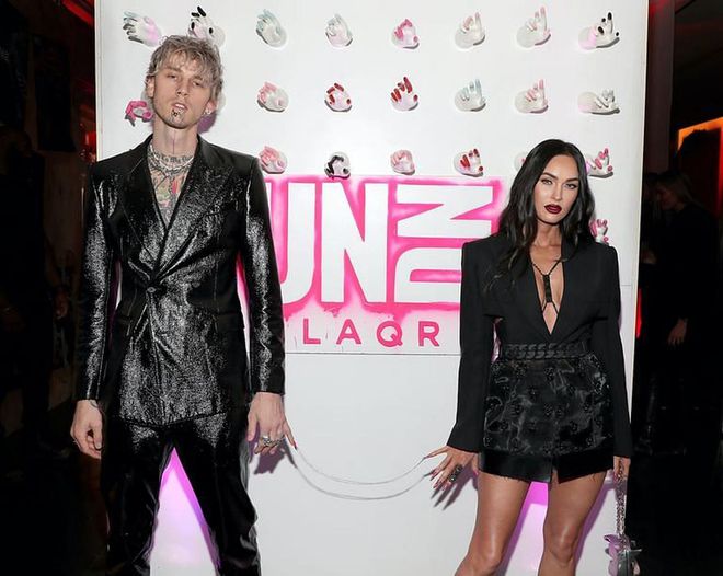 Megan Fox and Machine Gun Kelly appear at an event chained together by their pinky nails. (Photo: Jerritt Clark/Getty Images)
