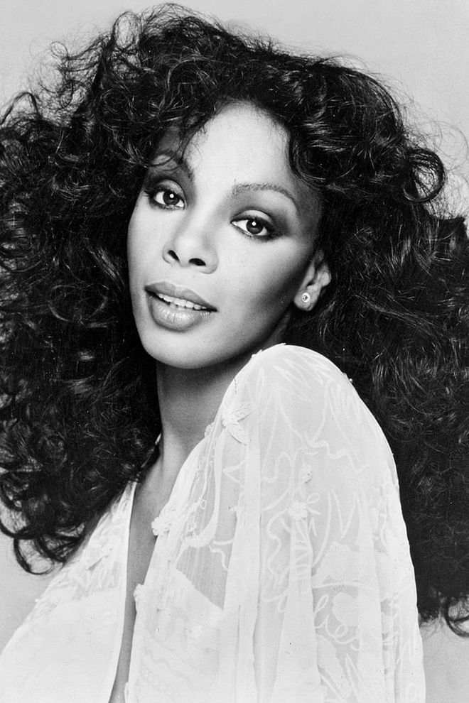 Disco curls, like the kind synonymous with Donna Summer, are not like other curls. They're fluffier, bigger, and look just as good going into the club as they do leaving it. It was the only hairstyle capable of competing with–or even topping— the colorful, low-cut, and bedazzled outfits of the era.
