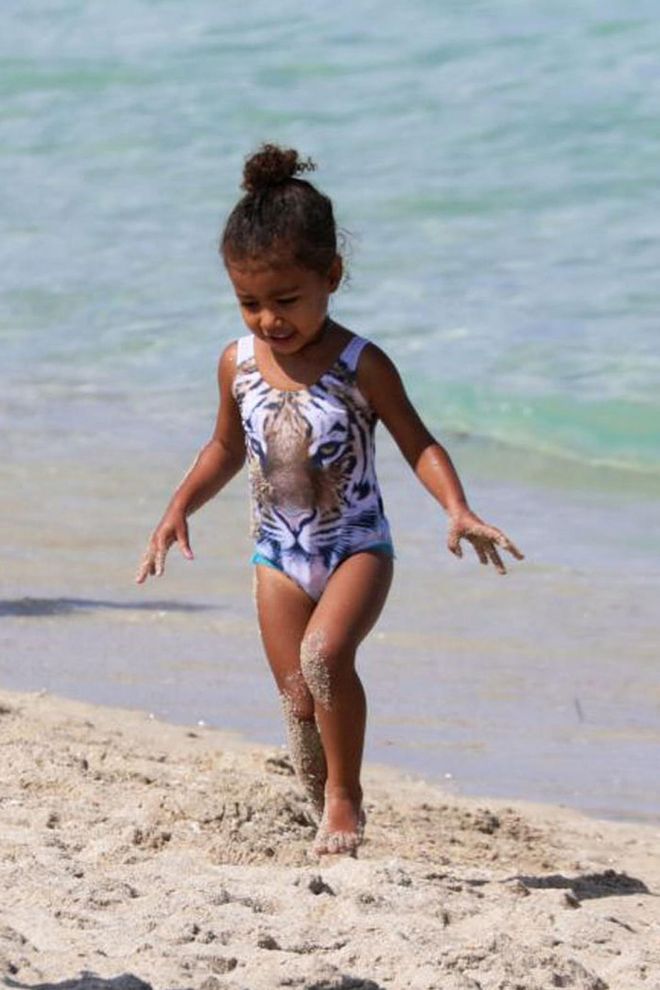 The Kardashian/West family took Miami this weekend for a friend's wedding. While Kim, Kourtney and Kanye spent time shopping and celebrating nuptials, North hit the beach for a day of fun in the sun wearing an adorable tiger swimsuit. Photo: Splash 