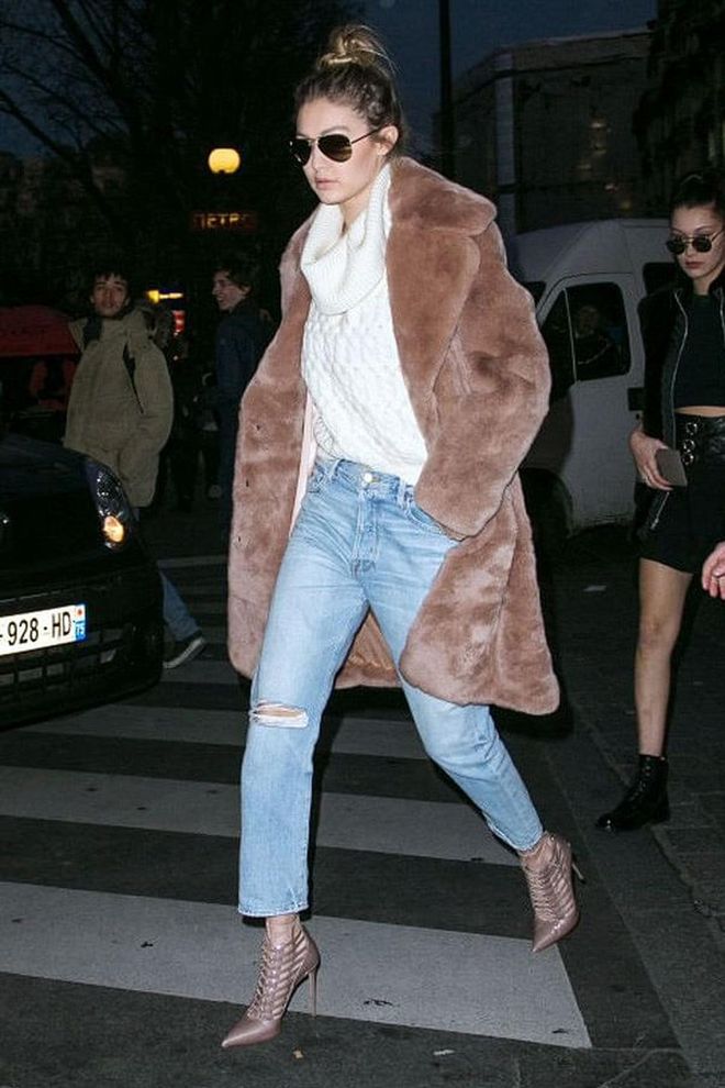 Gigi pulls of the 'cool girl' look effortlessly in a one x oneteaspoon turtleneck and Katie Ermilio fur coat, paired with distressed denim and pointy-toed booties.