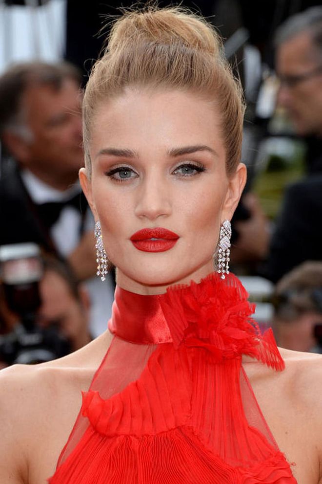 The style: A sleek, high bun with striking red lips made Rosie Huntington-Whiteley stand out on the red carpet. Photo: Getty 