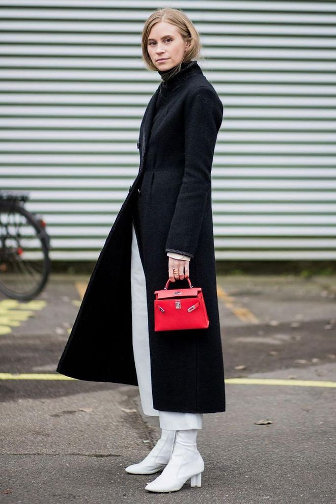 Team white boots with white trousers for an undeniably effortless and minimal look. A simple black wool coat will accentuate this style even further.

Photo: Getty