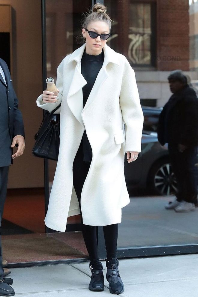 Gigi also does monochrome like a pro. She wears a long white coat over more casual athleisure clothing for an effortless look. 