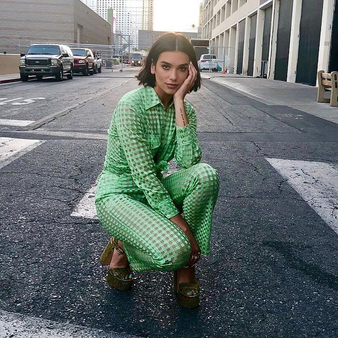 Dua performed her song "Homesick" at the BBMAs encore stage in Vegas wearing a gingham sheer tulle shirt and pant set by Adam Selman x Opening Ceremony. This key lime green was topped off with a pair of glittery platform sandals by Laurence Dacade, the whole outfit a citrus-y feast for the eyes. 
Photo: Instagram
