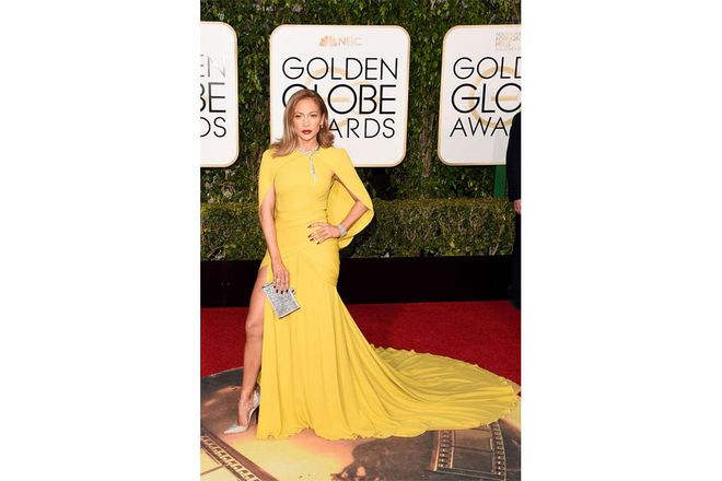 J. Lo described her gown as marigold, and we loved the cape, and thigh-high slit of the boldly-hued gown.