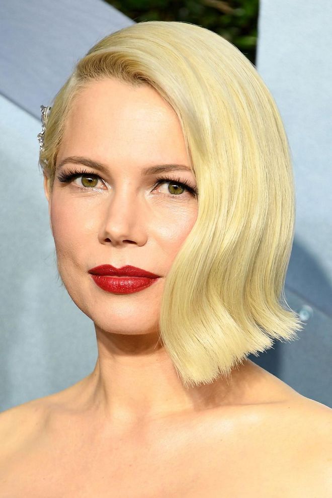 Chic as ever, Michelle Williams wore her platinum bob parted low to one side with a dazzling hair slide placed above her ear. To complement the retro glamour, she wore a classic true red lipstick applied with the ultimate precision.

Photo: Steve Granitz / Getty