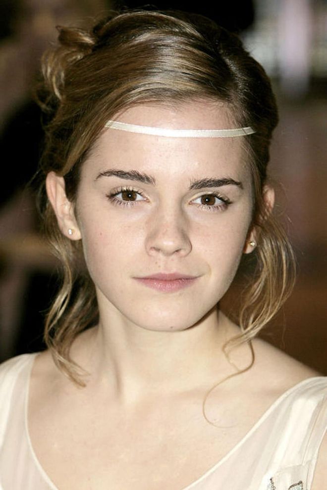 Watson has always had a love for headbands. Here, she wears an ivory one across her forehead.