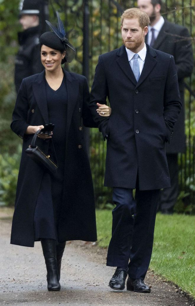 Meghan matched her husband in head-to-toe navy, accessorising her knitted Victoria Beckham dress with a matching coat, box bag, knee-high boots - all by Victoria Beckham - and feathered hat.