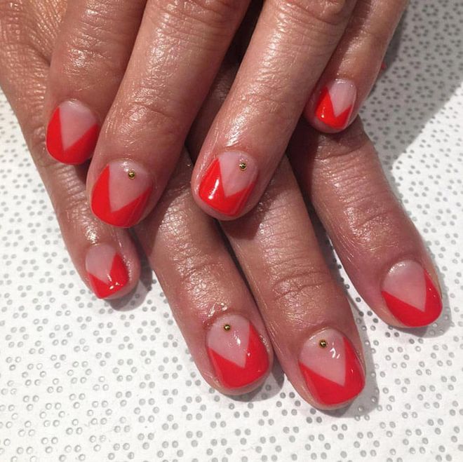 The holiday version of a negative space manicure requires swipes of vivid red and subtle gold embellishments. @fleuryrosenails