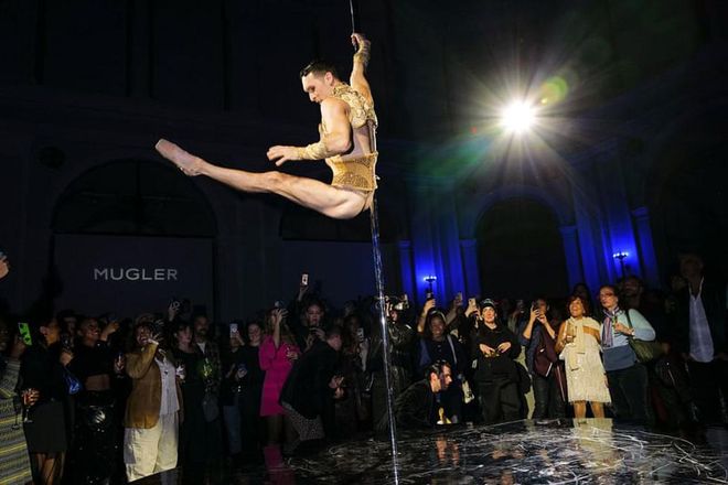 A guest pole dancing at the party, held two floors down from the exhibit at the Brooklyn Museum.
