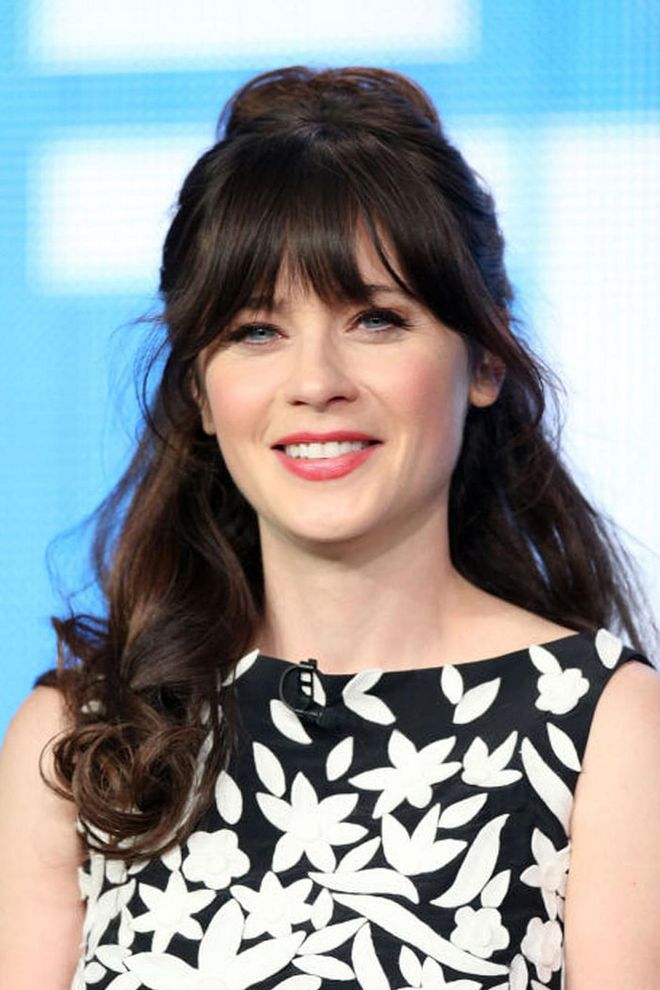 Deschanel knows the power of a chic top knot to break up a head of thick hair. Photo: Getty