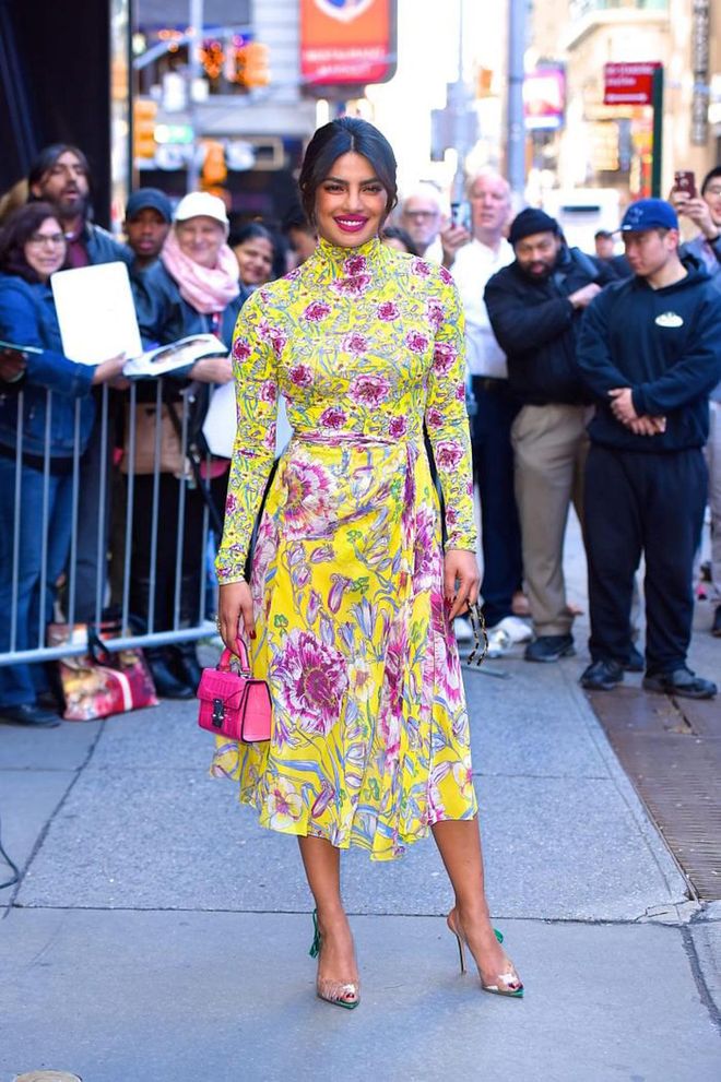 Rocking a bright neon floral look with a matching hot fushcia Stalvey top handle mini. Photo: Getty 