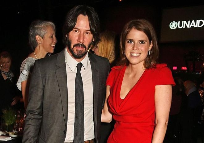 Keanu's keeping cool as a cucumber (as usual), but Eugenie has gone as red as her frock. Not that we can blame her. Photo: Getty 