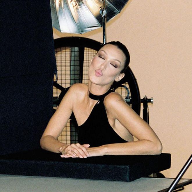 Hadid blows kisses to camera while on set with Charlotte Tilbury.