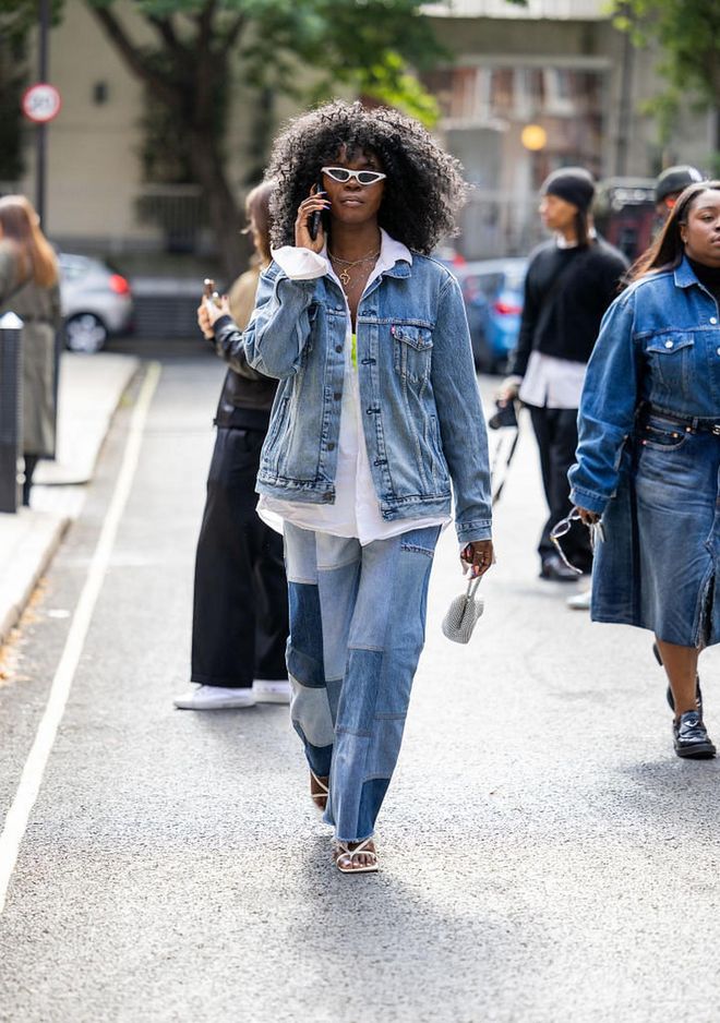 LONDON, ENGLAND - SEPTEMBER 18: Deborah Ababio wears denim jacket, jeans with patches outside 16Arlington during London Fashion Week September 2022 on September 18, 2022 in London, England. (Photo by Christian Vierig/Getty Images)