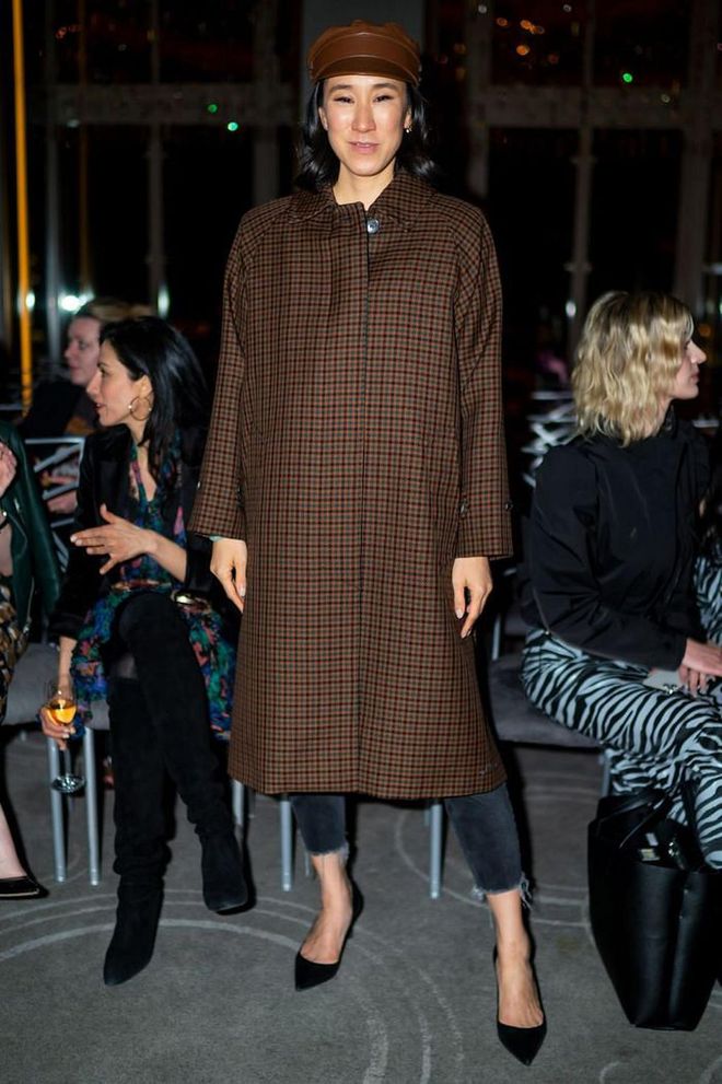 Eva Chen teamed a checked coat with a brown baker boy hat.

Photo: Getty