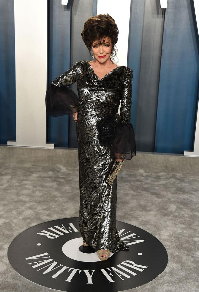 In a patterned metallic gown with sheer black cuffs. Photo: Getty