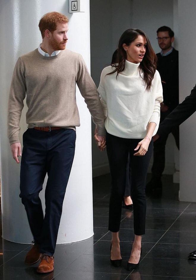 Inside Millennium Point during their royal visit to Birmingham, Meghan took off her navy coat to reveal a white All Saints sweater with a slight cowl neck. She kept it simple and chic with her favourite black Manolo Blahnik pumps. 