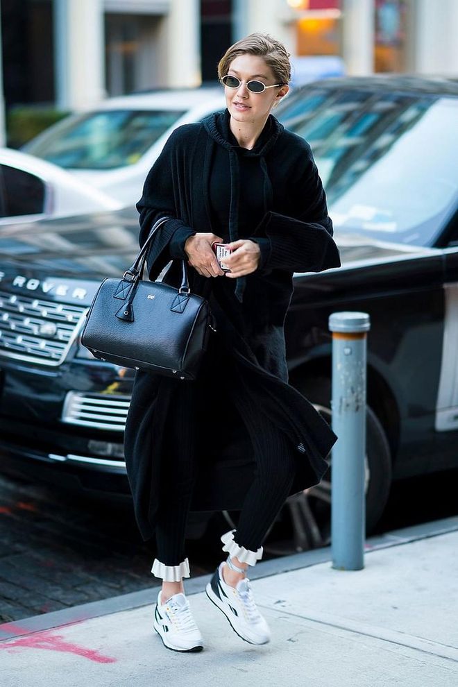 Donning her favourite black btop-handle bag my Mon Purse and dressed casually in a black hoodie and Reebok sneakers. 