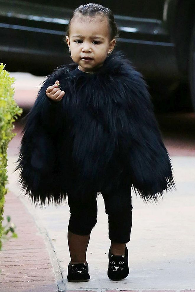 North takes childrenswear to the next level in a black fur cape styled with Charlotte Olympia cat loafers. Talk about the best-dressed kid on the playground...