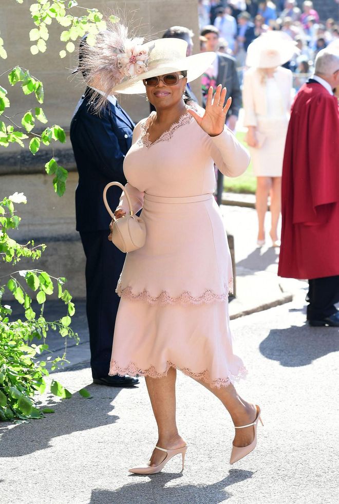 Oprah wears custom Stella McCartney and a Gabriela Hearst handbag. Photo: Getty