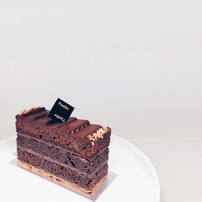 <b>We recommend:</b> The Monarch. This moist chocolate offering is an explosion of deep, chocolatey goodness with every bite. We also love the bed of crunchy feuilletine that it sits on, that addes dimension on the palate.  Photo: Instagram (@pantler)