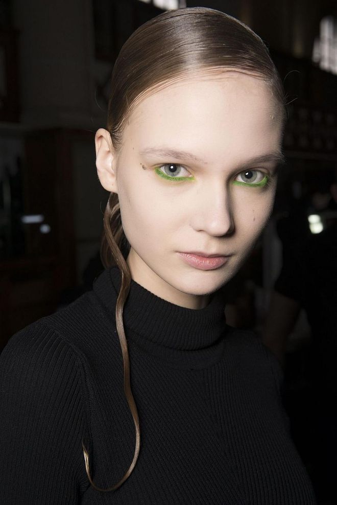 At Iris Van Herpen, models walked the runway with slicked-back hair and almost no visible makeup other than a technicolor pop of neon underliner.