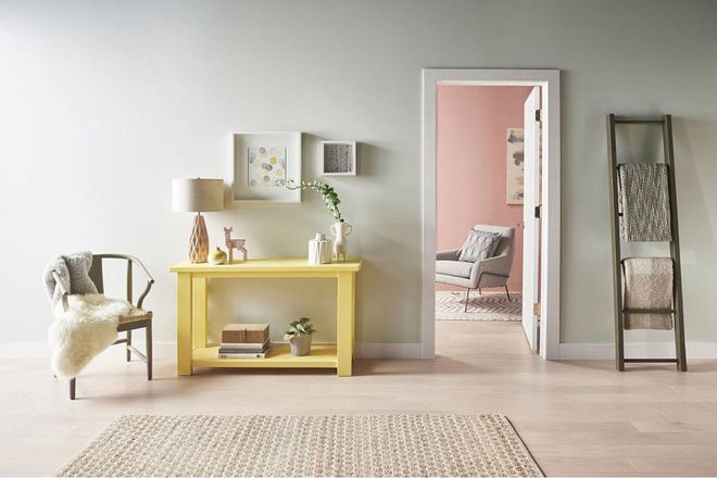 Bright accent pieces – like the soft yellow console – energize this room's muted gray walls. Get the look: Gold Hearted by Behr. Photo: Behr