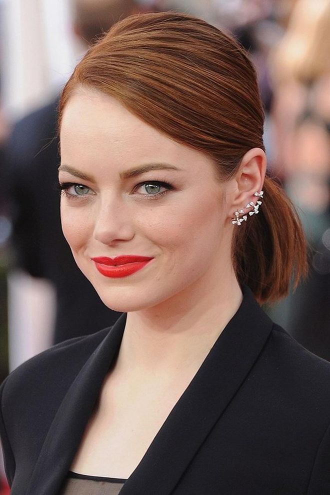 Emma Stone’s neat, side-parted low pony is an easy updo for short hair.