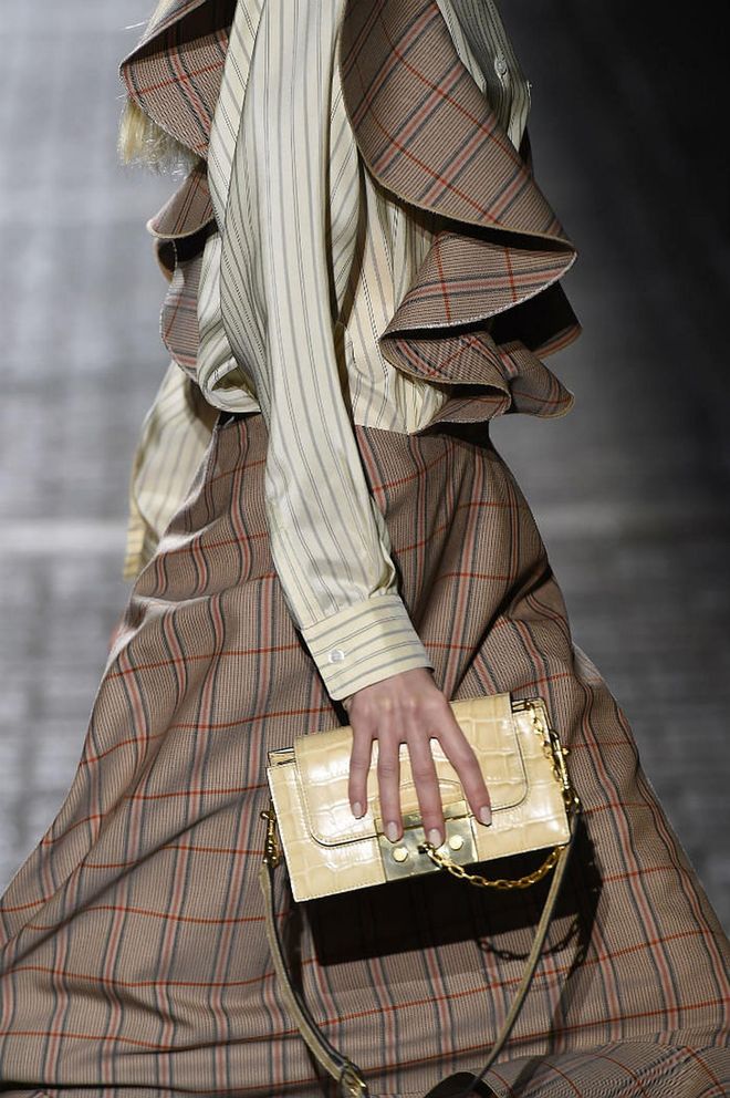 Seen at: London Fashion Week//Why we love it: Mini bags are all the rage right now. But this cream-coloured number spells "luxury" with the use of croc skin and twinkling gold accents. (Photo: Getty)