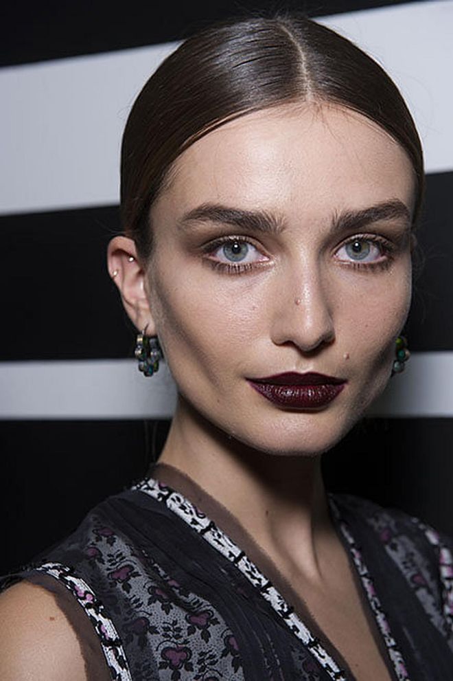 Another strong, dark lipstick look was seen at Bottega Veneta, where the hair stylist Guido Palau created sleek, sophisticated, centre-parted knots.