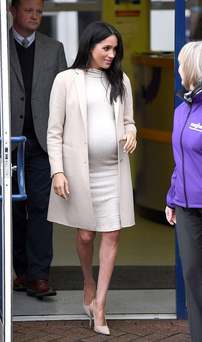 Meghan visited Mayhew Animal Welfare Charity as Patron in a chic monotone outfit, featuring a high-neck knit dress by H&M and a beige cashmere coat by Emporio Armani. We love this high-low combination, topped off with Paul Andrew camel sling-backs. 