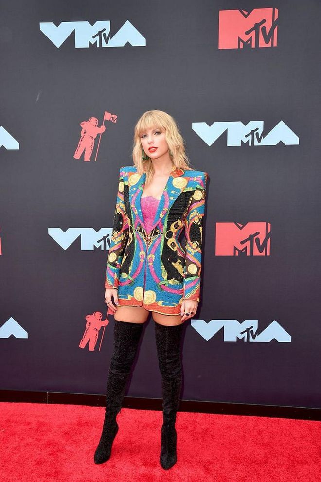 In a sparkling Versace blazer and Christian Louboutin boots.

Photo: Getty