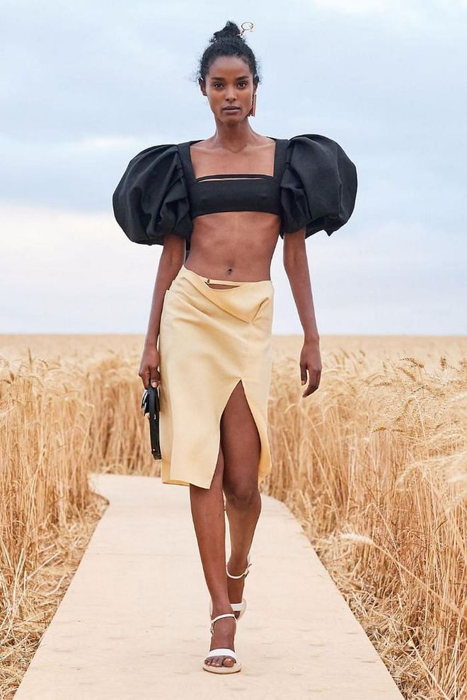 Never one to miss an Instagram opportunity, even during a pandemic, Simon Porte Jacquemus staged his spring 2021 collection for his namesake label in barley fields in Vexin Regional National Park. Here, he presented coquettish slipdresses in cream, black, and yellow; exaggerated shirts that were cropped or featured plunging necklines; and pencil skirts with high slits. Several references were made to provincial life, including gingham tops and frocks with appliqués that mirrored barley leaves and spikes. And not to be outdone were the accessories: spiral earrings in the vein of Joan Miró, miniature wicker bags, a carryall that held a single plate, necklaces and bracelets made of soap (yes, you read that correctly), and strappy heels. 
