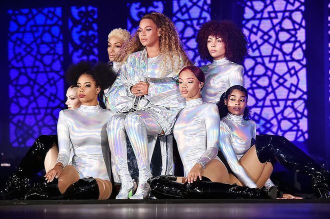 In a futuristic silver metallic jacket and matching boots. Photo: Getty