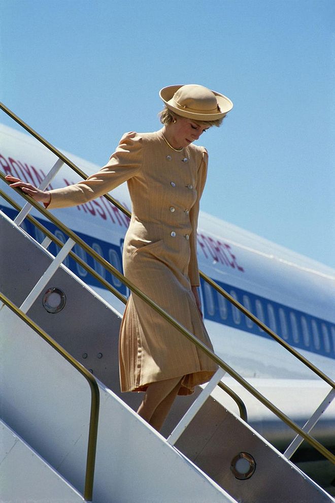 Arriving in Australia in a camel coat and matching hat. Photo: Getty