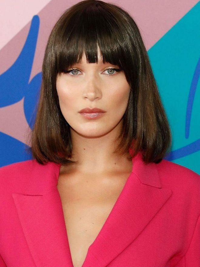 The '90s are back and they're here to stay. Bella Hadid and hairstylist Jen Atkin created this '90s looking blunt bob with roller-under ends that also evokes Michelle Pfeiffer's iconic hair from Scarface.