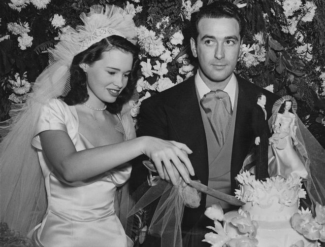 Gloria Vanderbilt (AKA Anderson Cooper's mother) married her first husband Pat DiCicco in 1941, when she was just 17 (and yep, she wore an iconic set of Vanderbilt pearls, because as the saying goes, "All Vanderbilt Women Have Pearls"). They divorced just four years later.

Couple of fun facts: The train on Gloria's dress was 30-feet long, and that little cake topper is wearing a replica of her outfit. Photo: Getty 