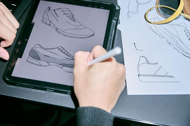 Kean sketches designs on his iPad