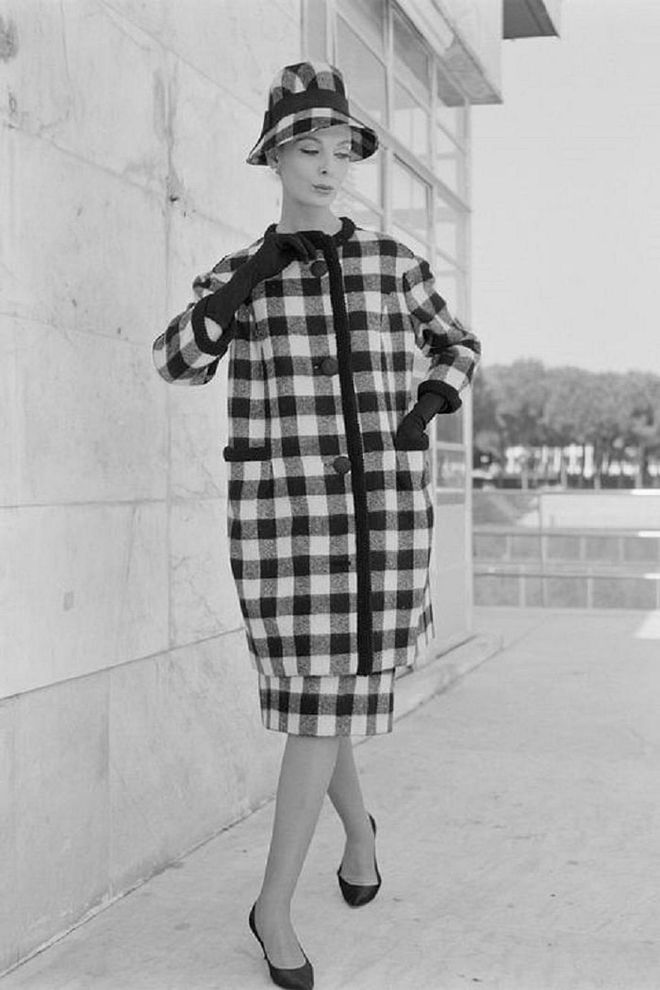 A woman modeling a checked winter coat and matching hat in Rome.

Photo: Getty