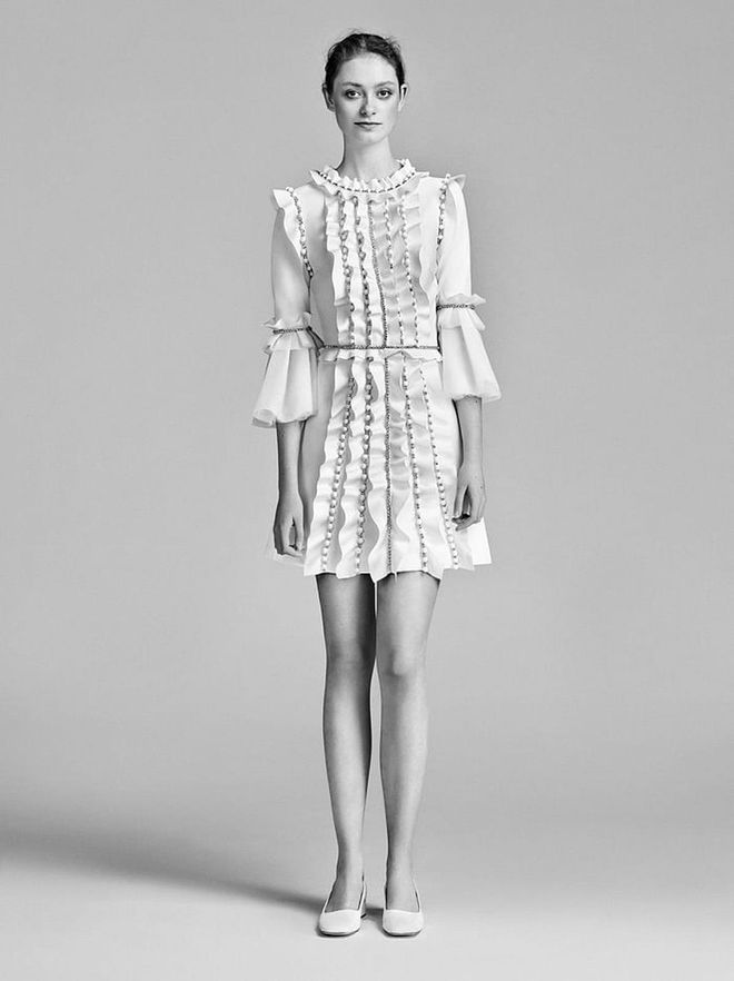 Ruffles, beading and bell sleeves feel less stuffy for a low- key affair in silhouettes with shorter hemlines. Viktor & Rolf "sparkle volant mini", viktor-rolf.com. 