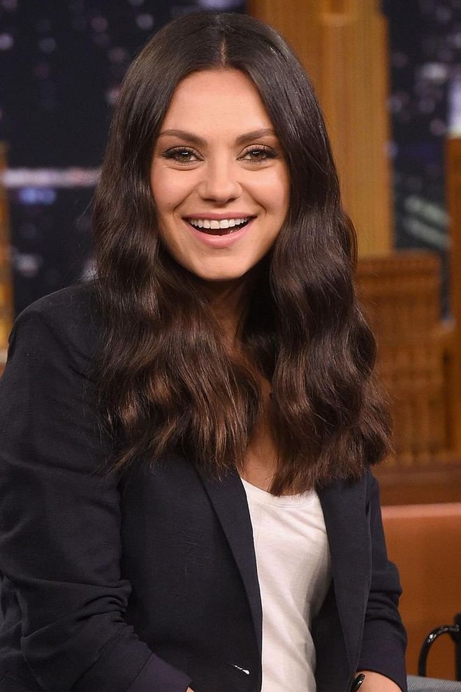Soft, brushed out curls and minimal makeup are what make Mila Kunis the ultimate girl next door. Photo: Getty