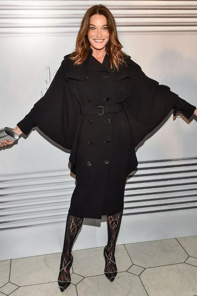 Carla Bruni wore a black caped jacket and skirt with lace tights.